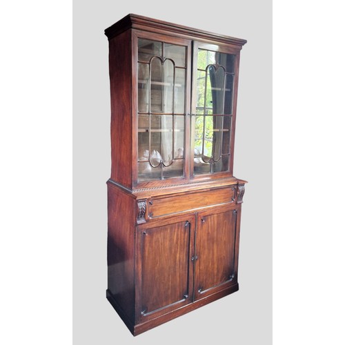 434 - A Regency mahogany secretaire bookcase, the moulded cornice above two astragal glazed doors, the low... 