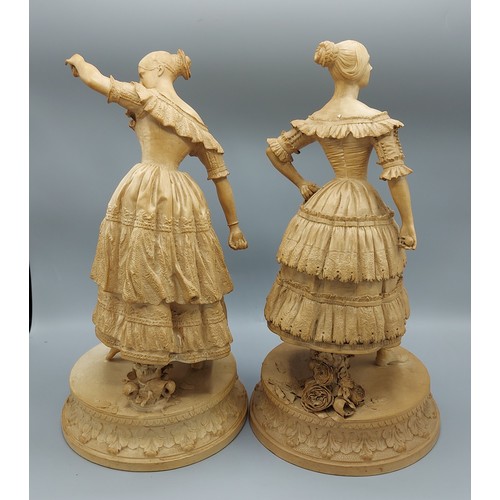 10 - A pair of 19th Century Parian ware figures of two ladies waring lace dresses upon circular bases, 37... 