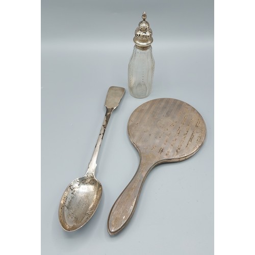 111 - A Victorian silver basting spoon, together with a silver backed hand mirror and a white metal glass ... 