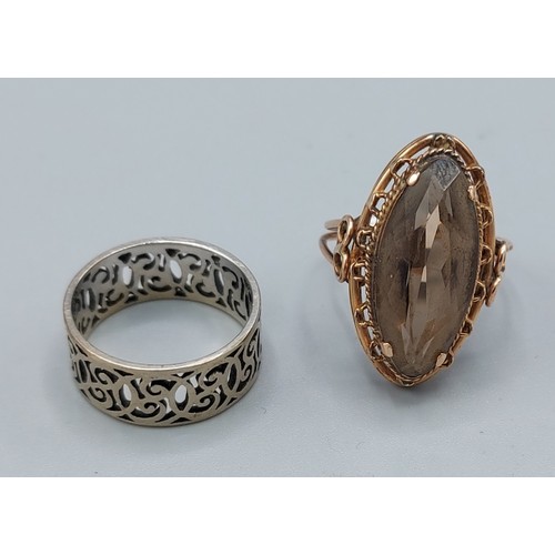 119 - A Citrine set dress ring together with a silver band ring