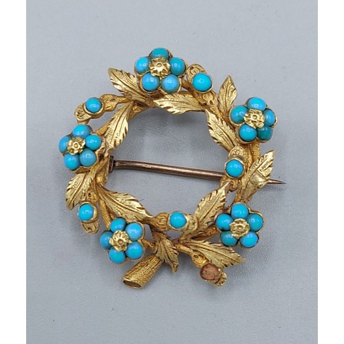 143 - A yellow metal brooch in the form of a wreath set with Torquoise, 6.4gms