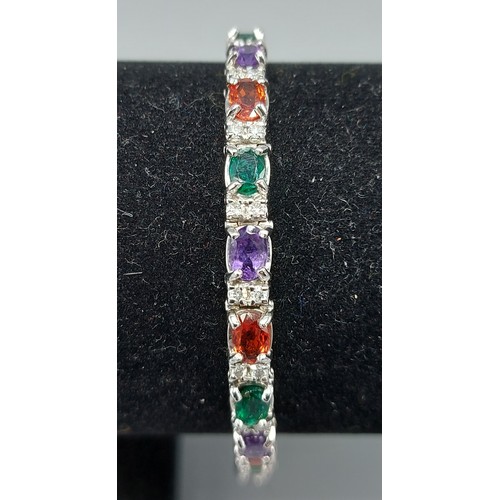 154 - A white gold bracelet set with Emeralds, Amethysts and Garnets interspaced with diamonds, 19.3gms, 1... 