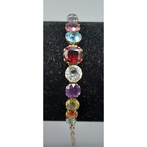 155 - A yellow metal bracelet set with eleven graduated stones to include Amethyst, 5.4gms, 19cms long