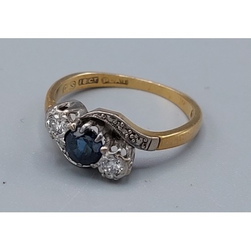 173 - An 18ct gold and platinum set sapphire and diamond ring of cross over form, 2.8gms, ring size H