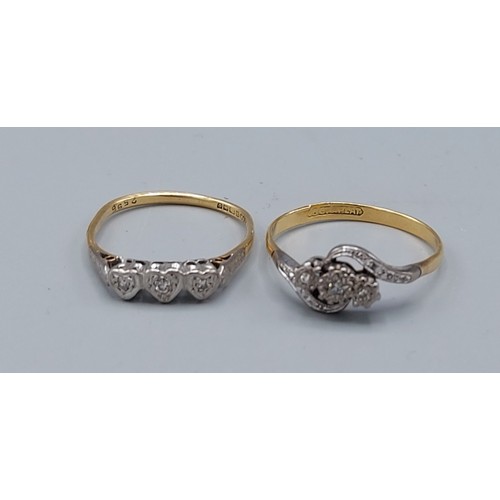 184 - An 18ct gold three stone diamond ring, 2.1gms, ring size Q together with another 18ct gold three sto... 