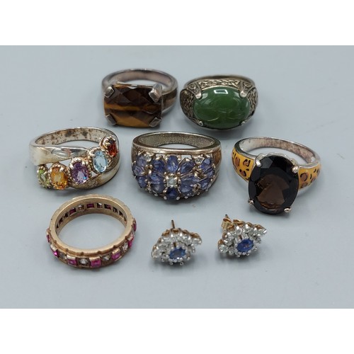 187 - A 9ct gold dress ring set with multi stones together with five other silver dress rings and a pair o... 