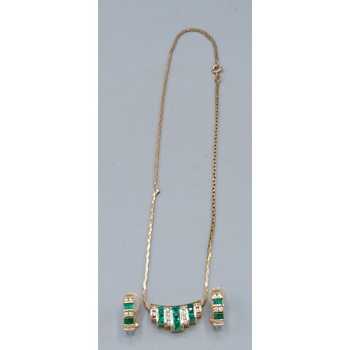 189 - A 9ct gold necklace, the pendant set with four rows of diamonds and three rows of Emeralds together ... 