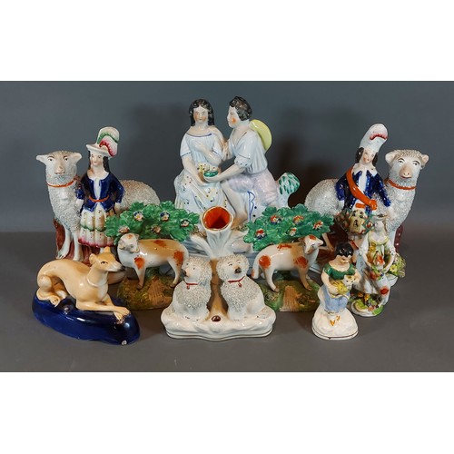 28 - A pair of Staffordshire pottery figure groups, together with a collection of Staffordshire pottery f... 