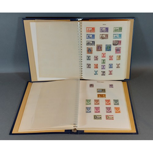 304 - Two Stanley Gibbons stamp albums containing stamps of the world mint and used, Gambia to Malawi