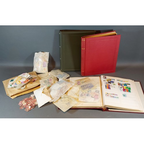 309 - An folder containing loose stamps, together with two empty stamp albums and a quantity of loose stam... 