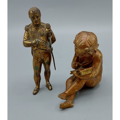 312 - A patinated metal model in the form of Napoleon, 12cms tall together with another bronze model of Pu... 