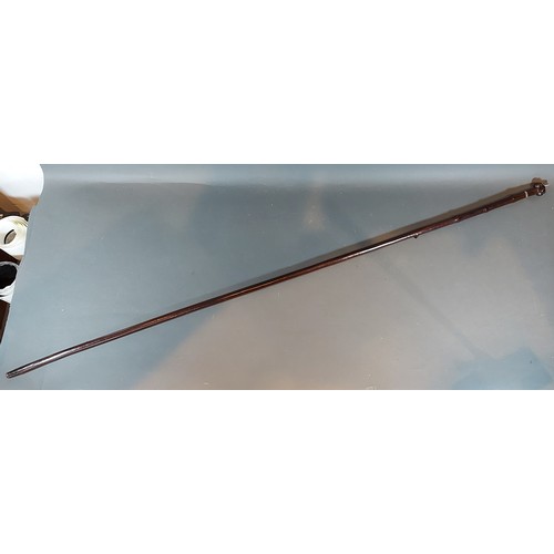 314 - An African tribal staff with white metal mounts, 126cms long