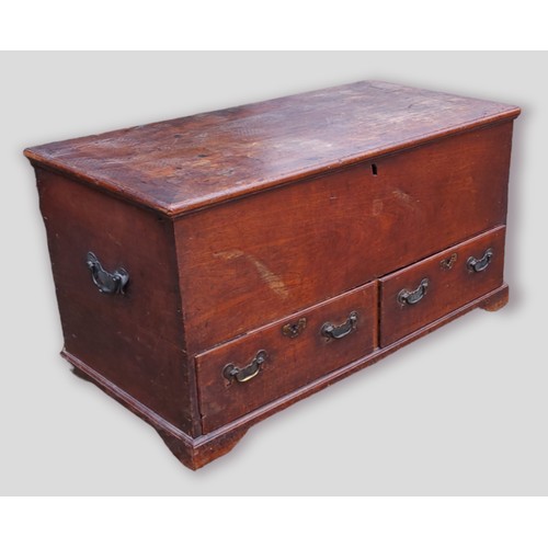 430 - A George III oak mule chest, the hinged top above two drawers raised upon bracket feet and side bras... 