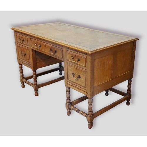 433 - An early 20th Century oak twin pedestal desk, the tooled leather inset top above five drawers with b... 