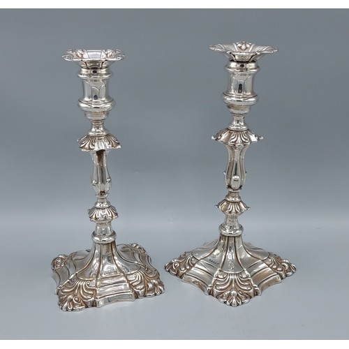 205 - A pair of 18th Century style silver plated candlesticks, 24cm tall