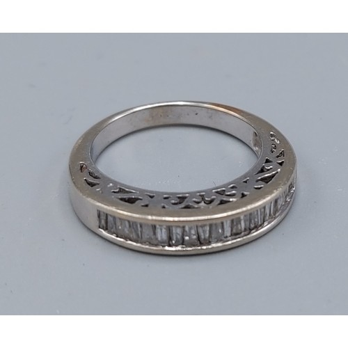 211 - A white gold half eternity ring set with baguette diamonds channel set, ring size N, 5.2gms