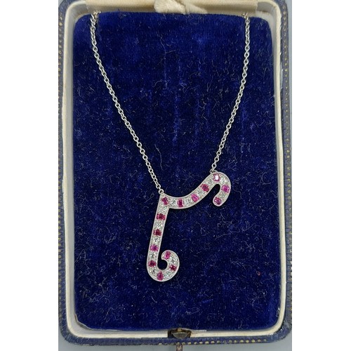 220 - A white metal pendant of shaped form set with rubies and diamonds with fine linked chain with certif... 