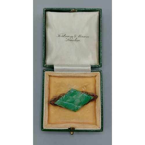 223 - A 9ct gold brooch set with green jade of lozenge form