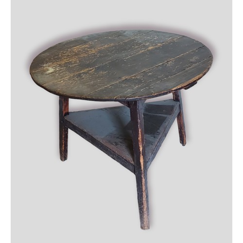 435 - An early cricket table, the circular top above three supports with under tier, 84cms diameter, 69cms... 