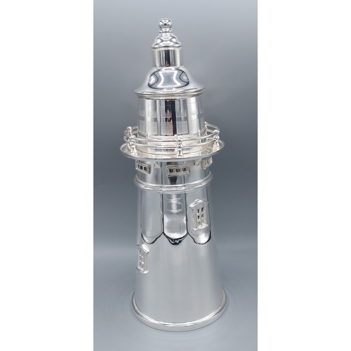 242 - A silver plated cocktail shaker in the form of a lighthouse, 34cms tall