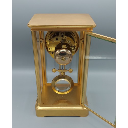 314 - A late 19th Century brass cased library clock, the enamel dial with Roman numerals and two train mov... 