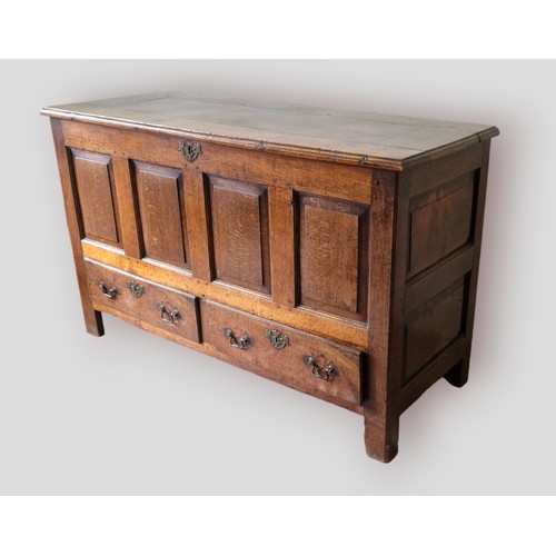 326 - A George III oak mule chest, the hinged top above a four panel front and two drawers flanked by stil... 