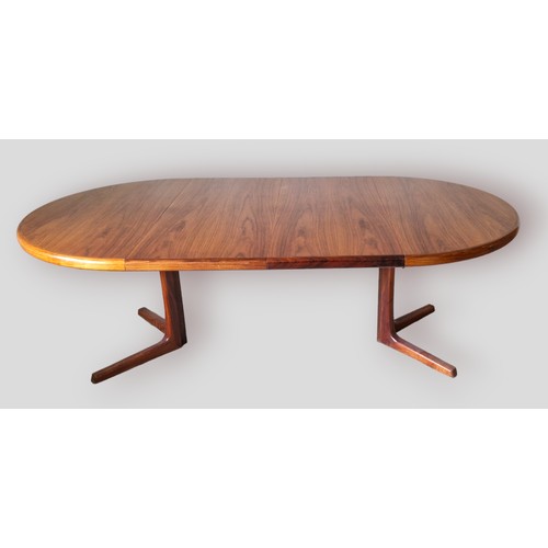 327 - A late 20th Century Danish circular extending dining table with two extra leaves, 120cms x 220cms fu... 