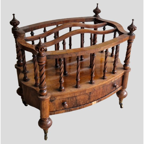 328 - A Victorian Rosewood shaped Canterbury, the three division spindle top above a frieze drawer and low... 