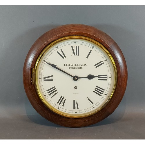 317 - An oak cased circular wall clock by Garrard, retailed by Leo Williams Petersfield, 34cms diameter