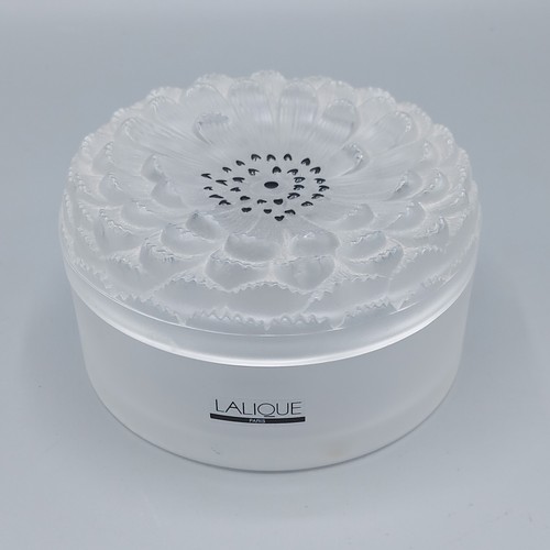 22 - A Lalique glass cylindrical box, the cover in the form of a flower head, 11.5cms diameter