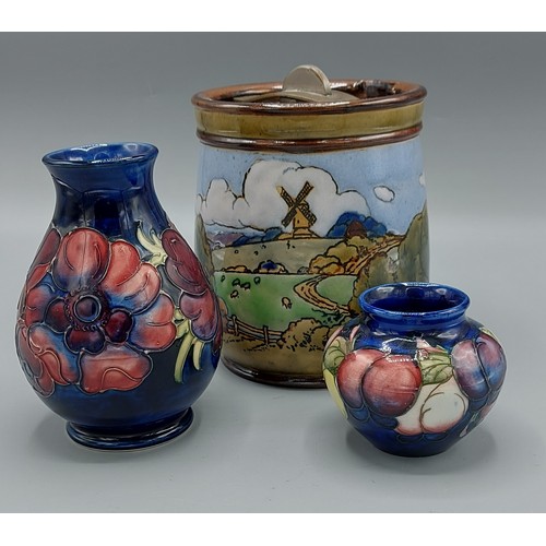 2 - A Moorcroft Anemone pattern vase, 14cms tall together with another Moorcroft small vase, 7cms tall a... 