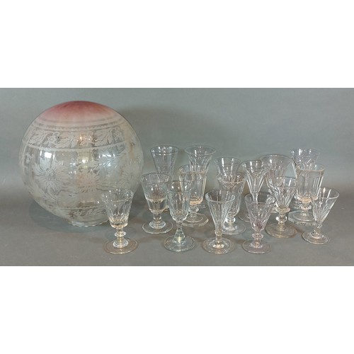 24 - A collection of early drinking glasses together with a engraved glass oil lamps shade