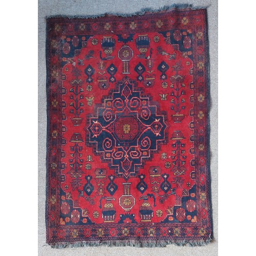 327 - A Northwest Persian woollen rug with an all-over design upon a red and blue ground within multiple b... 