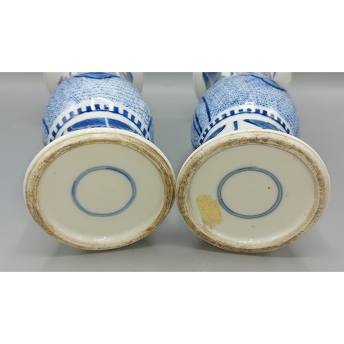 25 - A pair of early 19th Century Chinese flared rim vases, underglaze blue decorated with serpents and f... 