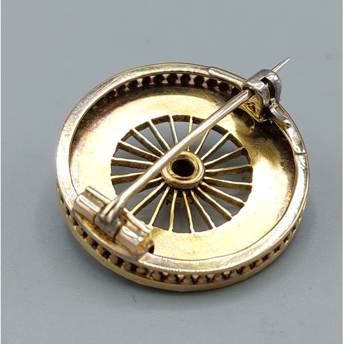 179 - A yellow metal brooch in the form of a wheel set with pearls, 2.3cms diameter, 7.1gms