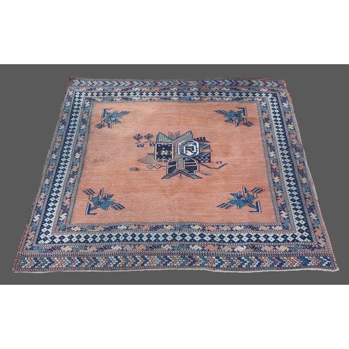 329 - A Northwest Persian woollen rug with central medallion within an all-over design on a terracotta gro... 