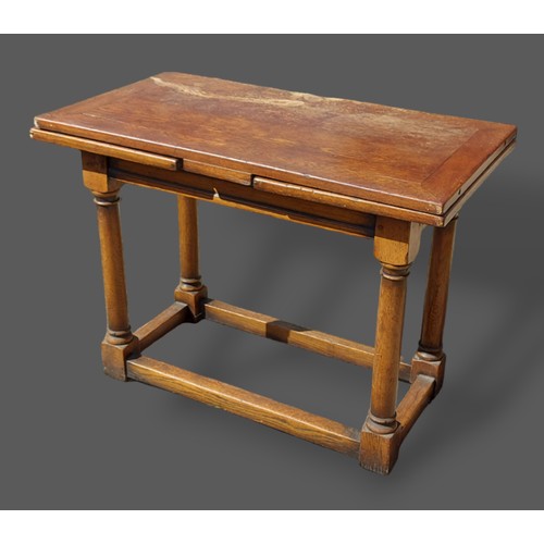 419 - An oak small refectory drawer leaf dining table with a moulded frieze raised upon turned legs with s... 