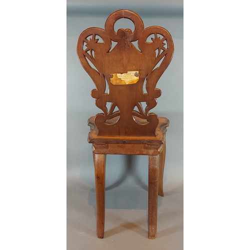 274 - A 19th Century swiss marquetry inlaid musical childs chair, with a pierced back above a moving seat ... 