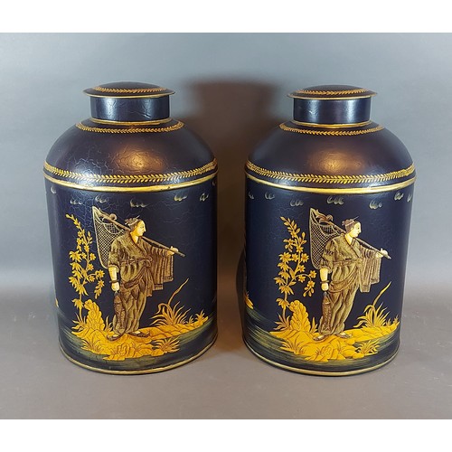 301 - A pair of Toleware cannisters with Chinoiserie decoration on a navy blue ground, 36cms tall