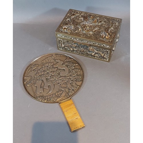 314 - A Chinese brass box with relief decoration, together with a Japanese hand mirror