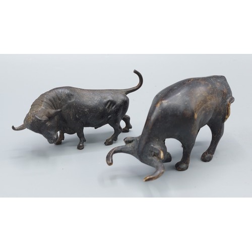 315 - A bronze model of a bull, 10cm long, together with another bronze bull