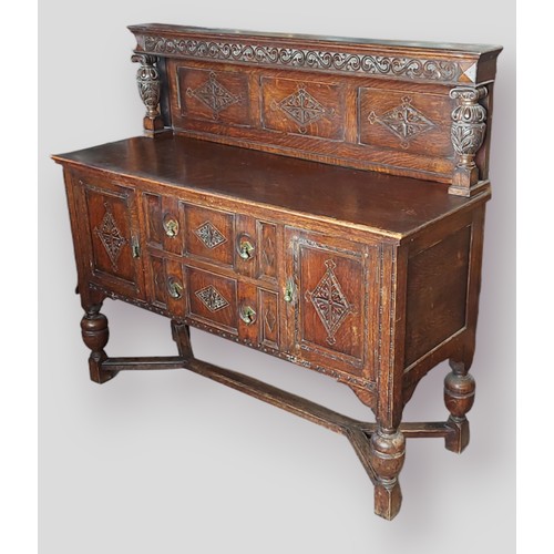 429 - An Edwardian carved oak side cabinet, the carved panel back with end pillars above a moulded top wit... 