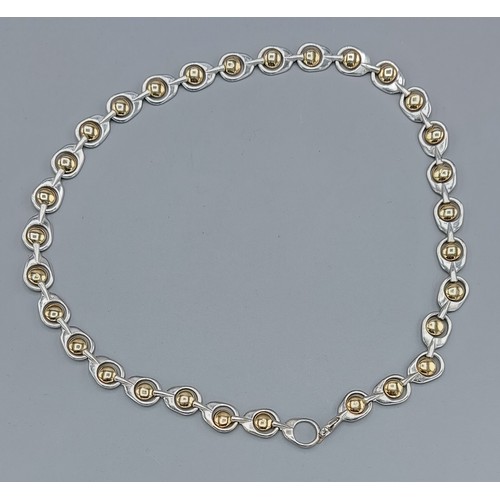 140 - Brett Payne, a silver and gold mounted necklace of linked form withing fitted box, 95.8gms, 52cms lo... 