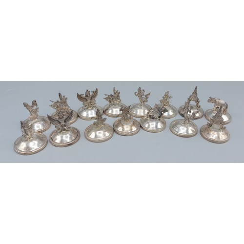 186 - A set of fifteen sterling silver menu holders, decorated with figures and animals