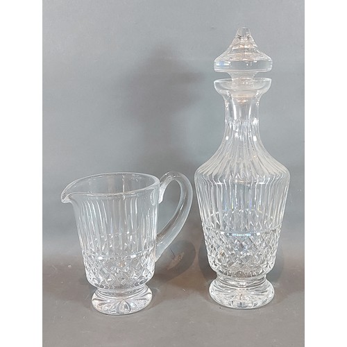 26 - A Waterford Tramore pattern glass decanter, 32cms tall together with a matching jug