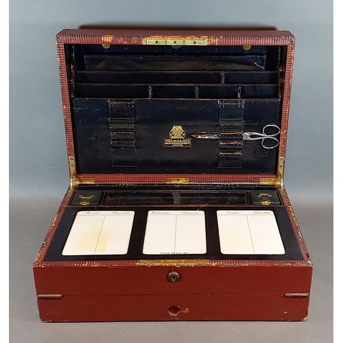 231 - An early 20th Century leather bound writing box, the hinged cover enclosing a fitted interior by Tou... 