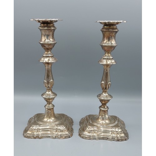 109 - A pair of Edwardian silver candlesticks with shaped stepped bases, Sheffield 1906, 24cms tall