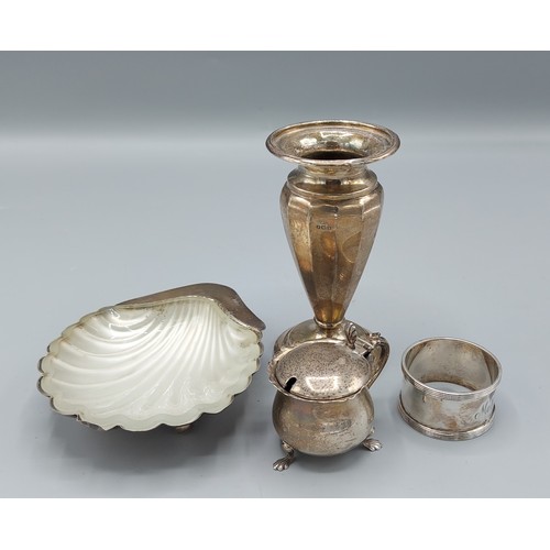 111 - A Sheffield silver butter dish of scallop form together with a Birmingham silver spill vase, a Birmi... 