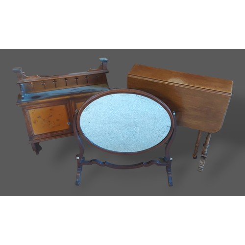 325 - A lacquered wall cabinet together with an oval swing frame mirror and a Sutherland table