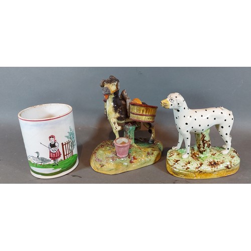 20 - A Staffordshire model of a Donkey with Panniers together with a Staffordshire model of a dog and Vil... 